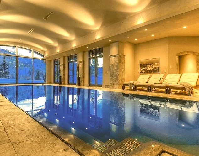 Pool house - huge transitional indoor stone and rectangular pool house idea