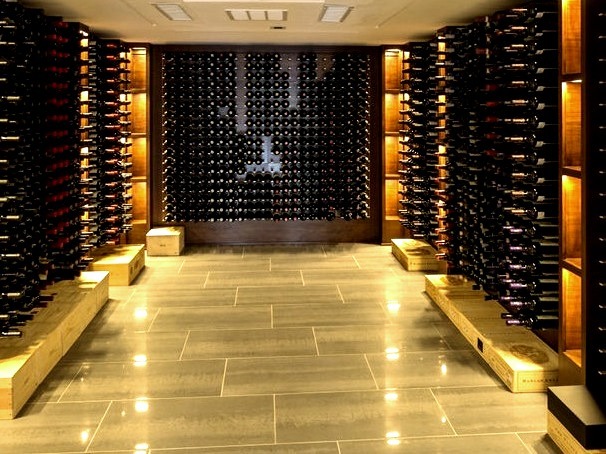 Large, modern image of a wine cellar with a gray floor and storage racks